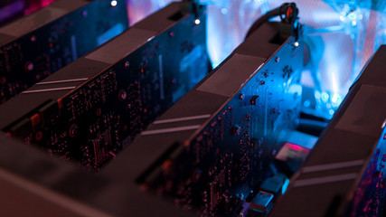 Fototapete - Close-up equipment for mining crypto-bitcoin, ether. Video cards, motherboards, blue lights