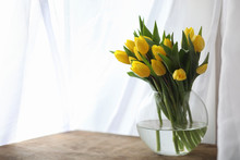 A Bouquet Of Yellow Tulips In A Vase On The Windowsill. A Gift T