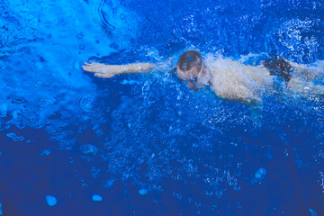  Male swimmer at the swimming pool. Underwater photo. Male swimmer.