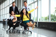 © opolja - Cheerful colleagues having fun in office chairs.