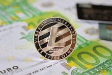 LiteCoin On Euro Banknotes Background With Credit Cards