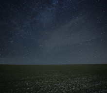 A Beautiful Landscape With Meadow With Grass  In The Night With Starry Sky Above