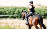 Picture of young girl riding her horse