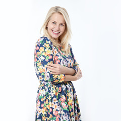 Wall Mural - friendly smiling middle-aged woman i in blue dress solated on white background