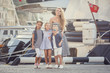 © Olena_Molchanova - The elder sister and younger sisters and a brother in a marine style against the backdrop of boats and yachts. Idea and concept Friendship, vacation, vacation, family