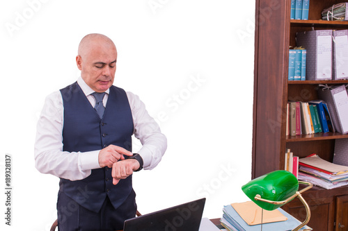 Fotografie, Obraz A businessman uses smartwacth pic, at desk, at work.