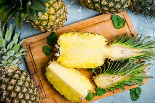 Fotografía Fresh ripe pineapples on the rustic background. Selective focus.