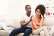 © Prostock-studio - Young black couple making peace after quarreling at home