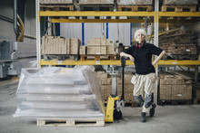 Senior Warehouse Worker With Pallet Cart