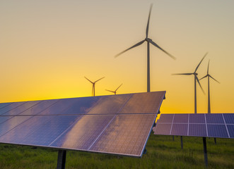 Wall Mural - wind generators turbines and solar panels on sunset