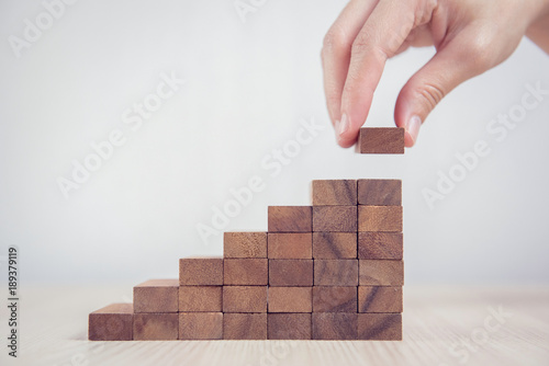 Cuadros en Lienzo Close up Woman hand arranging wood block stacking as step stair
