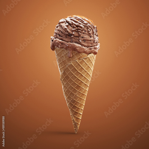 Fotografía Close-up delicious coffee ice cream in waffle cone with chocolate cream and caramel isolated on brown background