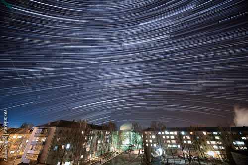 Fotografering Night Star Trails Over Rural Town at winter