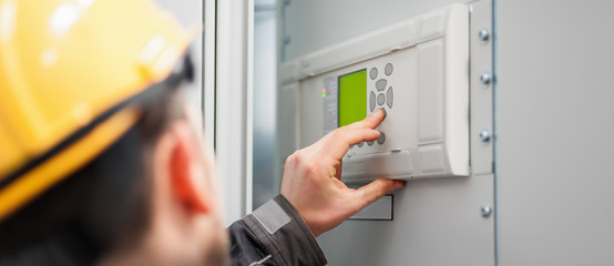 Wall Mural - close up of maintenance engineer testing voltage switchgear