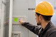 © guruXOX - Maintenance engineer testing voltage switchgear and bay control unit