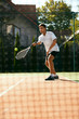 Man Playing Tennis Outdoors.