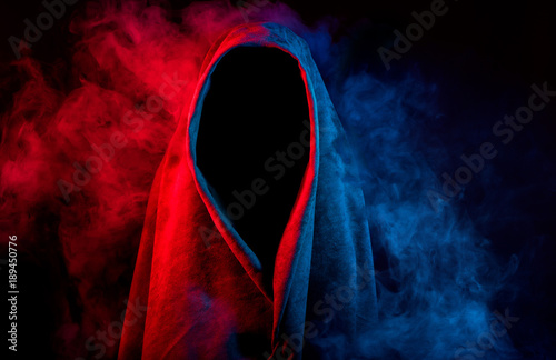 Fotografía mysterious dark silhouette hidden by colorful smoke on black background