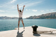 © Laszlo - Carefree woman jumping at beach. Beautiful travel destination. Baska harbour, Krk island, Croatia.