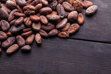 Wall Mural - Raw cocoa beans on dark wood