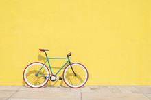 A City Bicycle Fixed Gear On Yellow Wall