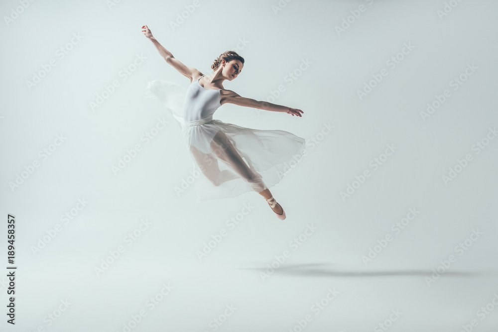 elegant ballet dancer in white dress jumping in studio, isolated on white - obrazy, fototapety, plakaty 