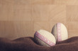 Easter background with easter eggs on woolen mat with copy wooden space