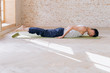 © yuliyalyashok - Relaxed young man doing yoga and meditating in studio