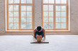 © yuliyalyashok - Relaxed young man doing yoga and meditating in studio
