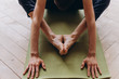 © yuliyalyashok - Relaxed young man doing yoga and meditating in studio
