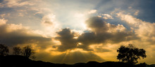 Panoramic Sunset With Clouds In The Twilight Sky With Mountain Silhouette