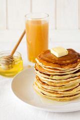 Wall Mural - Stack of pancakes with butter and honey on white background