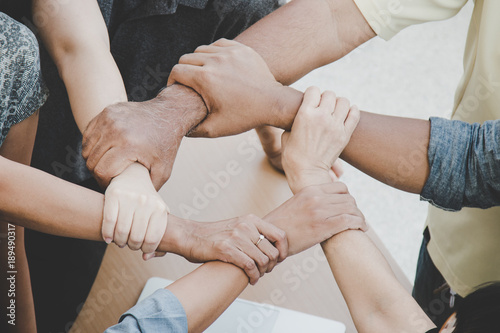 Fotografía Team work concept; close up of joining hands of businessman in unity cross proce