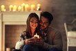 © Africa Studio - Happy young couple with burning candle at home