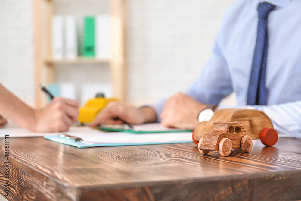 Car models and blurred people on background. Vehicle insurance