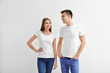 © Africa Studio - Young woman and man in t-shirts on white background. Mockup for design