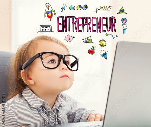 Photo Entrepreneur text with toddler girl using her laptop