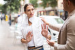 © JackF - Unhappy girl getting rid of unwelcome stranger outdoors