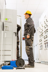 Wall Mural - field service engineers inspect system with relay test set equipment