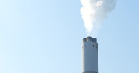 Wall Mural - Chimney and smoke over blue sky