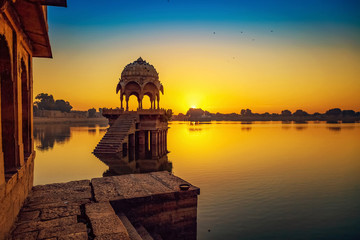 Fototapete - Gadi Sagar Lake Jaisalmer Rajasthan with ancient architecture at sunrise.