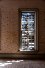 Sunlight Through Old Shutters On Window In Abandoned Building
