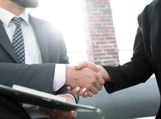 Close-up of two business people shaking hands