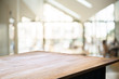 © mojo_cp - empty wooden desk over blurred montage coffee shop cafe / restaurant background