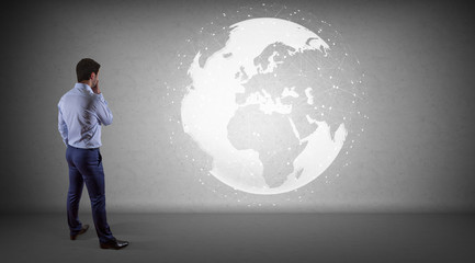 Poster - Businessman using digital planet earth interface on a wall 3D rendering