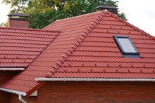 New Red Shingles Roof With Skylights Windows And Rain Gutter. New Brick House With Chimney