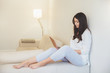 © VK Studio - Indoor shot of restful female with dark hair, dressed in casual clothes, enjoys calm atmosphere at home, updates software on notebook, connected to wireless internet. Student studies indoor.