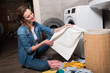 © LIGHTFIELD STUDIOS - housewife taking clothing to put it into washing machine at home