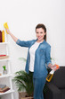 © LIGHTFIELD STUDIOS - portrait of attractive woman with rag and disinfect spray cleaning home