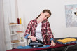 © LIGHTFIELD STUDIOS - portrait of woman talking on smartphone while ironing clothes at home