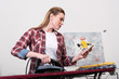 © LIGHTFIELD STUDIOS - woman using smartphone while ironing clothes at home